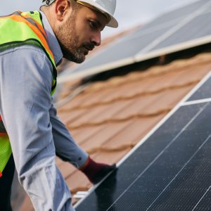 Solar panel engineer working on the rooftop.